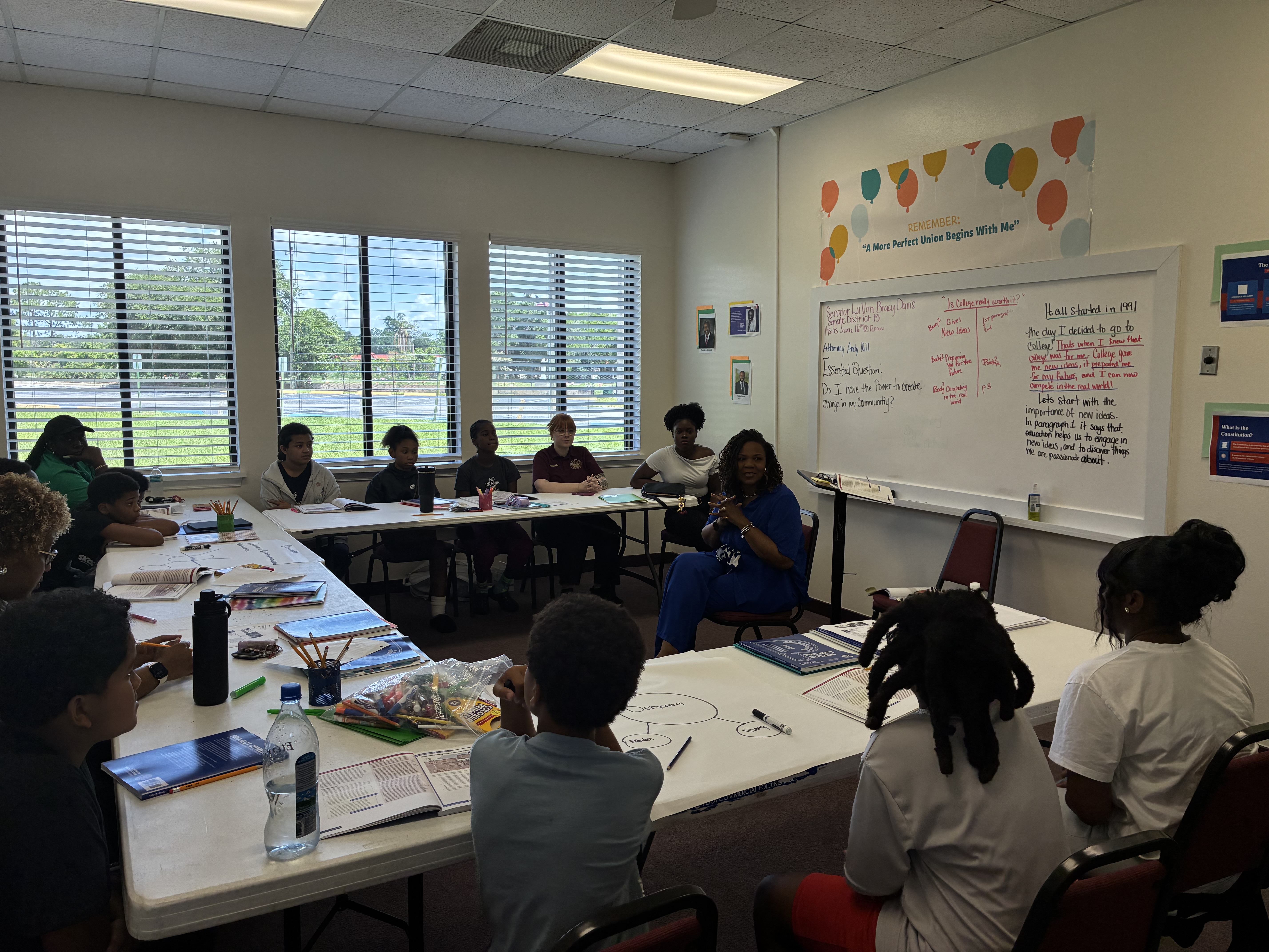 A class of students engaged in a lesson with community leader Senator LaVonne Bracy